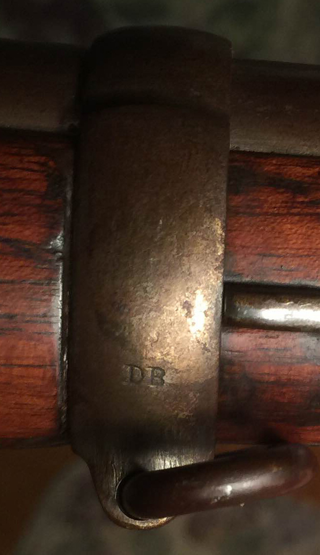 The middle barrel band stamped with the letters 'DB'.
