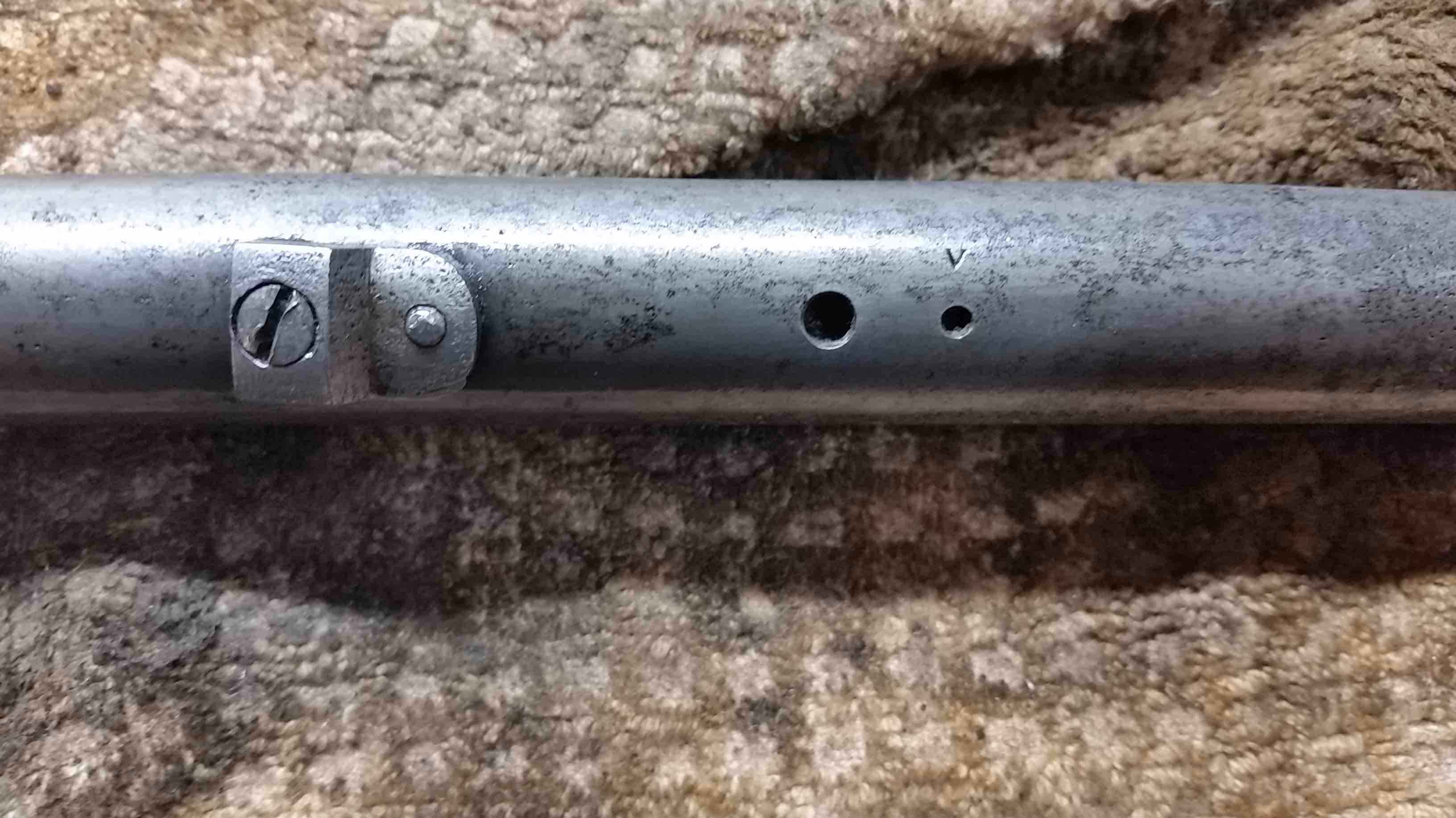 &quot;V&quot; on the underneath of the barrel.