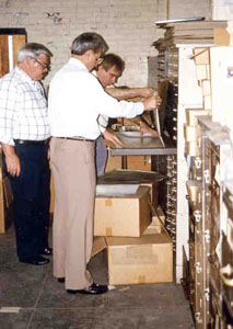 Photo of Jay Lewis, Jack Heath and Chuck Decanic looking over the early Remington records.